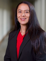 Dr. Juliana Reece, female with dark black hair wearing black blazer and red blouse