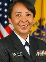 CDR Lynette Wasson, female with dark hair wearing a black service uniform